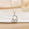 Silver heart necklace with owls and sparkling crystals on a white ceramic tray - Silver Heart Two Owls/Side Diamond