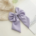 Elegant lavender fabric bow hair clip placed on a vintage book for a soft aesthetic look - Light Purple