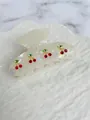 Close-up of white acetate hair claw clip with sparkling red cherry rhinestone designs - Approx. 8cm / White