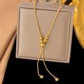 Luxurious gold snake chain necklace with delicate beads displayed on a jewelry box - Slide Lucky Bead / Gold