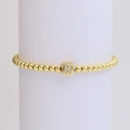 Golden beaded stretch bracelet with a crystal-encrusted square H letter pendant - Letter H