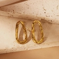 Detailed shot of golden hollow oval earrings on a stone base with silk background - Irregular Oval Hollow Style