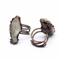Detailed close-up of wire wrapped bronze rings with natural raw agate druzy crystals - White Crystal