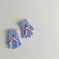 Detail of light blue knitted gloves with pink bow and soft plush fuzzy texture - Approx. 2-6 Years Old / Blue