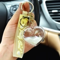 Yellow strap heart quicksand keychain with liquid glitter and acrylic heart charm accessory - White
