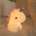 Unicorn silicone night light with pink mane and rainbow horn glowing in warm light - Sitting Unicorn (Battery-7 Colors)