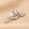 Detail of silver tulip brooch with sparkling rhinestones and white pearl on beige cloth - Double Tulip