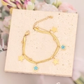 Detalle de una pulsera de doble capa dorada con estrellas y turquesa sobre piedra - Estilo de Múltiples Dijes de Estrellas (2#)