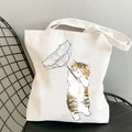 White canvas tote bag featuring a cute cat holding an umbrella cartoon print - Ginger Cat with Transparent Umbrella