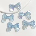 Light blue luminous resin bow beads with iridescent shimmer finish for DIY phone chains - 1 Bead / Glowing Glitter Light Blue
