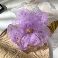 Elegant purple polka dot lace scrunchie made of light mesh fabric on a bamboo tray - Purple
