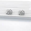 Silver round stainless steel stud earrings with textured wavy pattern on white stand - Swirl Pattern / Silver