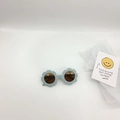Detailed close-up of light blue flower children's sunglasses with brown lenses and matte finish - Blue