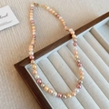 Detail of multi-color pearls in a velvet jewelry tray with a cozy knit background - 40# Yellow 6mm Pearl Necklace