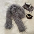 Flat lay of a grey faux fur scarf with headphones and coffee for a cozy winter vibe - Long Tassel Grey