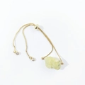 Close-up of adjustable gold box chain bracelet with natural yellow raw crystal and zircons - Prehnite