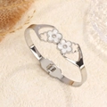 Silver stainless steel floral cuff bracelet featuring white shell flower charms - Steel