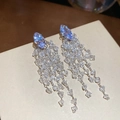 Detailed macro view of diamond-cut purple zircon tassel earrings on beige card display - Silver-Clear (49#Marquise Chain Tassel)