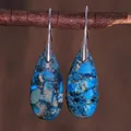 Detail of teardrop emperor stone earrings with blue texture hanging on wooden branch - Blue and Brown Mottled Texture Style (ER1025-13)