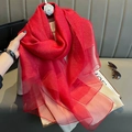 Detail of red silk scarf with gold glitter particles on premium sheer fabric texture - Red