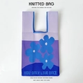 Macro detail of purple knitted bucket bag with blue flower pattern and text embroidery - Purple Blue Three Flowers