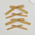 Set of four golden satin ribbon bow hair clips with long streamers in a vertical layout - Yellow (4pcs Set)