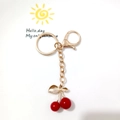 Golden cherry keychain variant with red fruit pendant and leaf charm on white dish - Red Cherry with Lobster Clasp and Gold Leaf (Cherry D)
