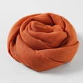 Solid orange cotton linen scarf for women, neatly folded into a rose flower shape - Orange