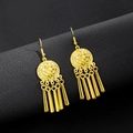 Close-up of golden bohemian fringe earrings with vintage textured disks on black leather - E5765-2 Hollow Disc Vertical Tassel