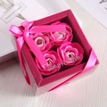 Exquisite gift box with four pink soap roses featuring a ribbon bow and clear packaging - 4 Pieces / Gradient Pink