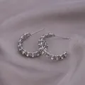 Silver-colored woven chain hoop earrings with small crystals on a silk background - E-074---Platinum