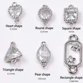 Macro detail of 14K gold plated cubic zirconia pendants in various geometric shapes - Heart (5.5mm) / Platinum Plated