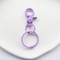 Macro view of lavender purple metal lobster clasp and large round ring hardware for bags - Purple