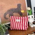 Red and white striped canvas makeup bag with zipper and decorative woven label - Red