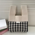 Detail of knit handbag with houndstooth pattern and brand label on beige woven fabric - 21*34cm / Beige