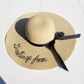 Close-up of Greetings from embroidered text on a beige wide-brim straw beach hat - M (56-58cm) / Beige (Greetings From Embroidery)