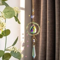 Golden suncatcher with peridot stones and crystal prisms casting rainbows on windows - Green Aventurine Circle