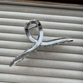 Close-up of a silver metallic hair claw clip with a strong spring on a soft velvet base - Cross Silver 13cm