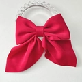 Classic bright red satin bow hair clip for women with elegant glossy finish on white plate - Red