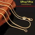 Elegant 1mm gold snake chain necklace displayed on wood with multiple length options - 18 inch / 1.2mm Snake Chain-18K Gold