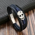 Detail of woven leather skull bracelet with magnetic clasp on a textured background - Dark Blue + Silver