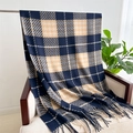 Detail of soft navy and beige plaid scarf with fringes draped on an armchair - Dark Blue & Beige Plaid (WT141-3)