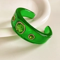 Detail of vintage resin cuff bracelet with green gemstones and sparkling rhinestones - Transparent Green