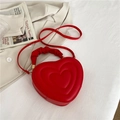 Bright red heart-shaped shoulder bag with quilted texture and ruched cloud handle - Red