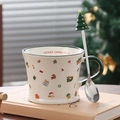 Macro detail of Christmas ceramic mug with green handle and tree-topped metal spoon - Christmas Gift (With Spoon)