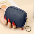 Dark blue pebbled leather mini wallet with gold zipper and keychain held in hand - Royal Blue
