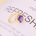 Minimalist gold open ring with a faceted purple round gemstone on a white background - Adjustable Open / Purple