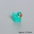 Macro detail of a 11x15mm miniature resin duck with green glow and silver glitter accents - Glow In The Dark Peacock Green