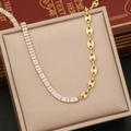 Golden stainless steel pig nose chain necklace with zircon stones on a beige display box - Necklace