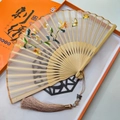 Handmade silk Suzhou embroidery folding fan with yellow floral patterns and long tassel - Golden Flower Auspicious